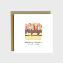 Load image into Gallery viewer, A funny greeting card featuring a yellow birthday cake with chocolate frosting and an abundance of candles on top of it with text that reads, Your birthday is becoming a serious fire hazard.